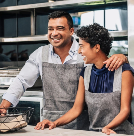 happy-small-business-owners-at-their-cafe